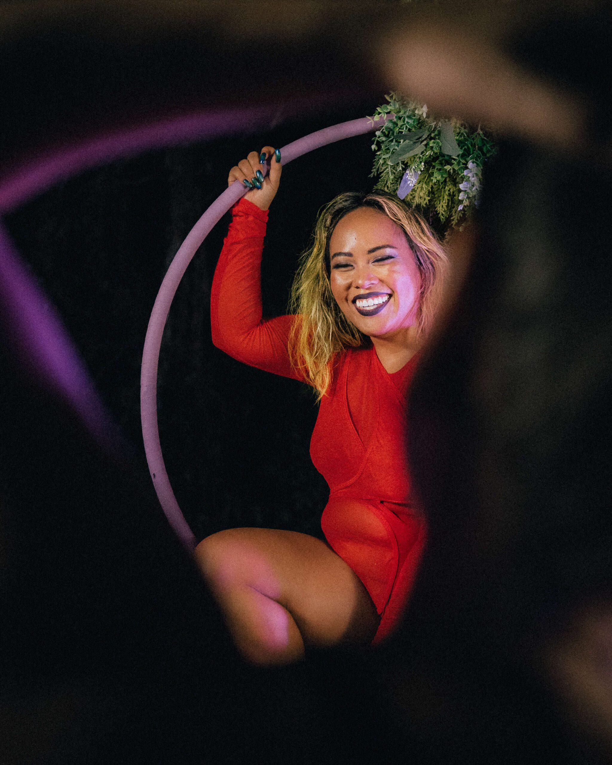 Aerial hoop with a stunning artist smiling through the frame of Lexis Potters arms.