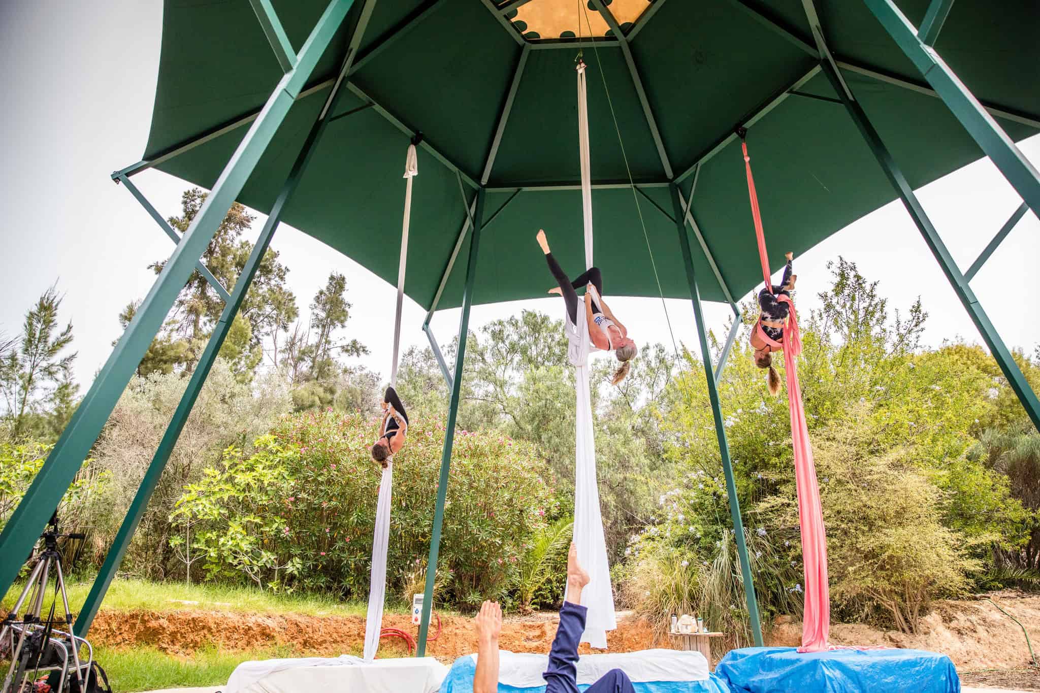 Aerialists playing on the outdoor rig at House of Honey Aerial Retreat Center